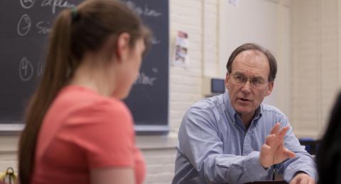 Image of student and teacher holding a discussion