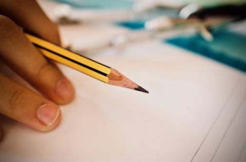 Student holding pencil in hand