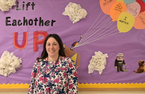Maureen in front of bright poster